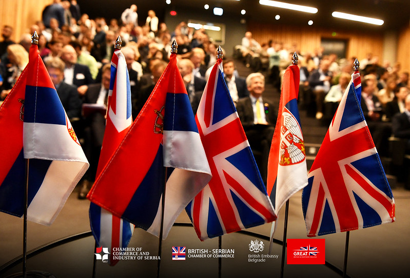 UK and Serbian flags displayed before delegates at a BSCC conference
